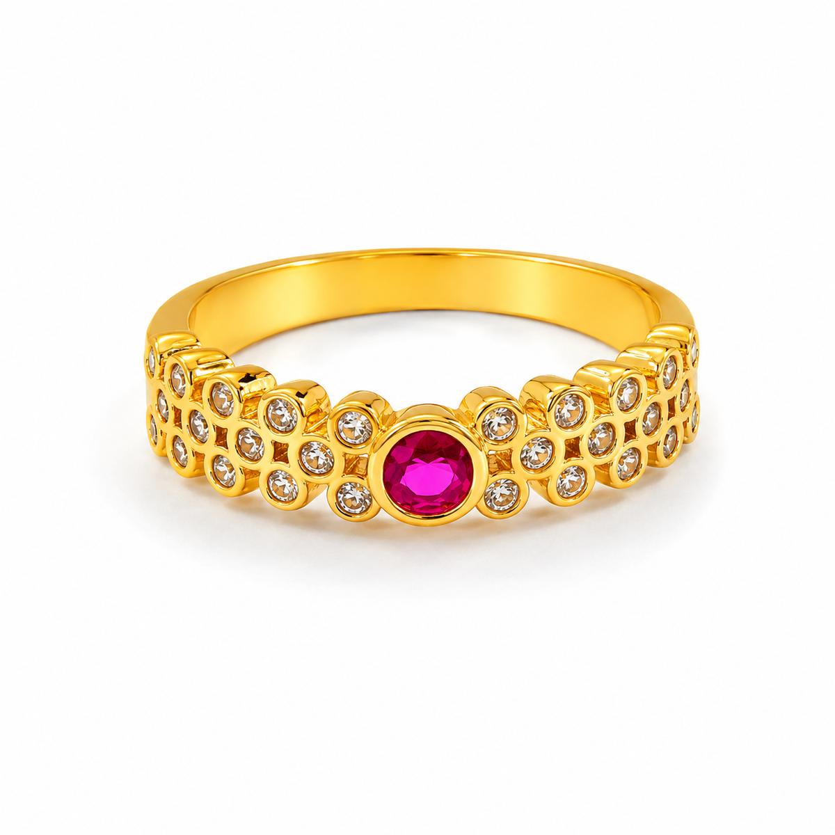 A yellow gold ring featuring a central round pinkish-red ruby gemstone surrounded by small clear cubic zirconia stones, with a repeating floral pattern on the band, shown on a white background.
