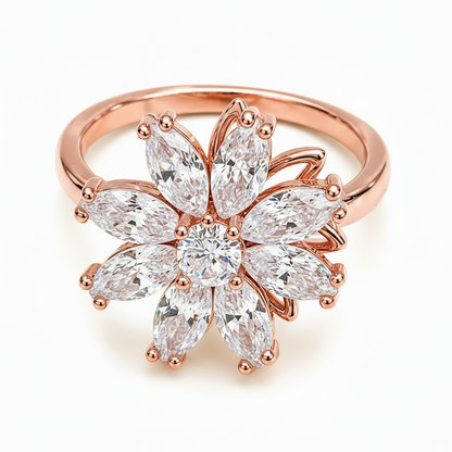 A gold flower-shaped ring featuring marquise-cut clear gemstones, photographed on a clean white background.