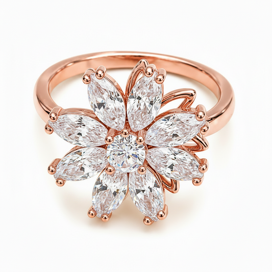 A gold flower-shaped ring featuring marquise-cut clear gemstones, photographed on a clean white background.