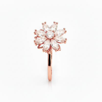 A rose gold flower-shaped ring with marquise-cut clear gemstones, shown on a clean white background.